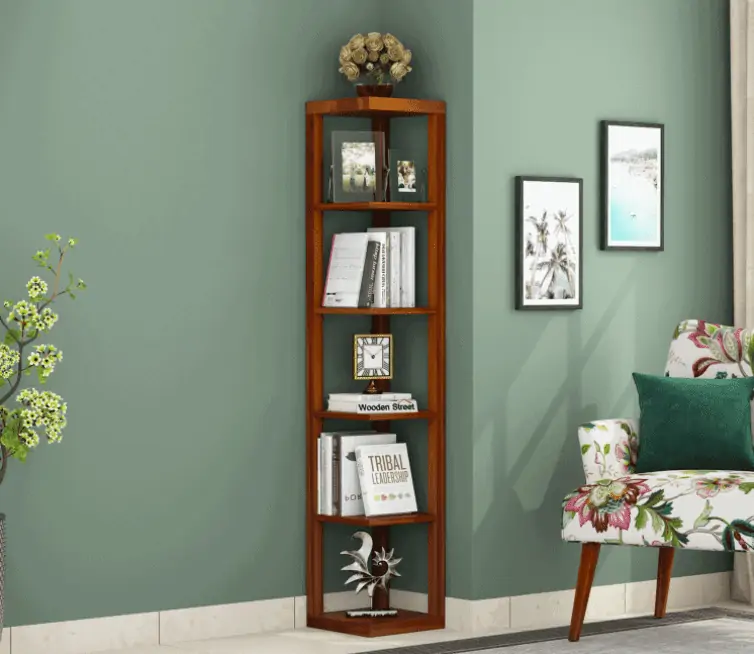 corner angular book stand, brown, green walls, room setting, books, showpieces, sofa, table