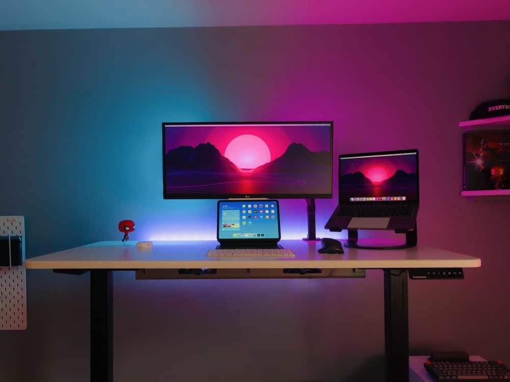 blue and red light room, computer, table, wooden top