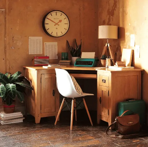 wooden corner furniture, white chair with wooden legs, wall clock, plants