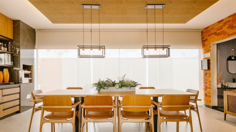 Elegant dining room with multiple layered, wooden, chairs, table, flooring