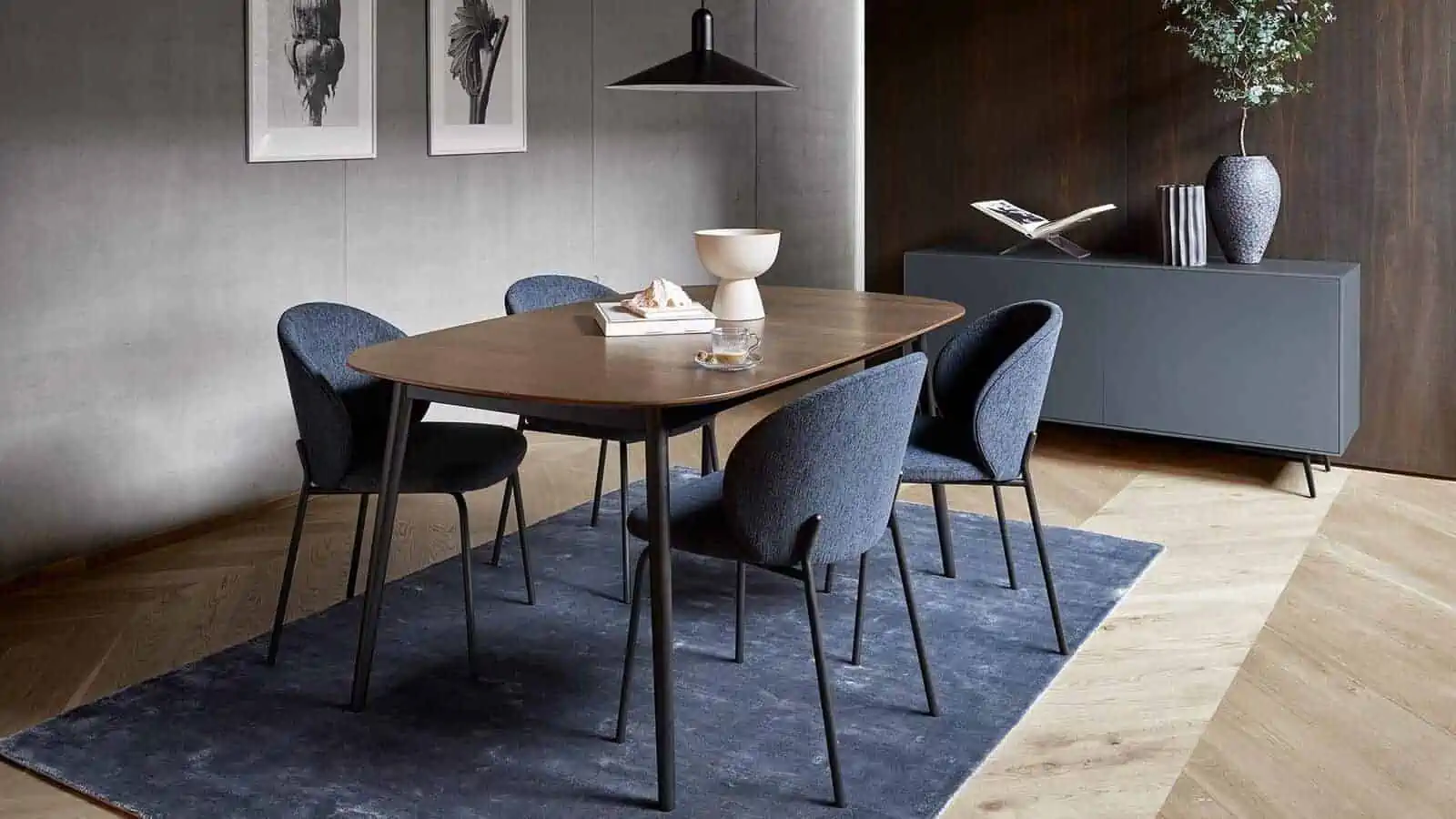 rectangular 4 seater dining table set with blue chairs, wooden top and dark brown frame, in a dining room setting