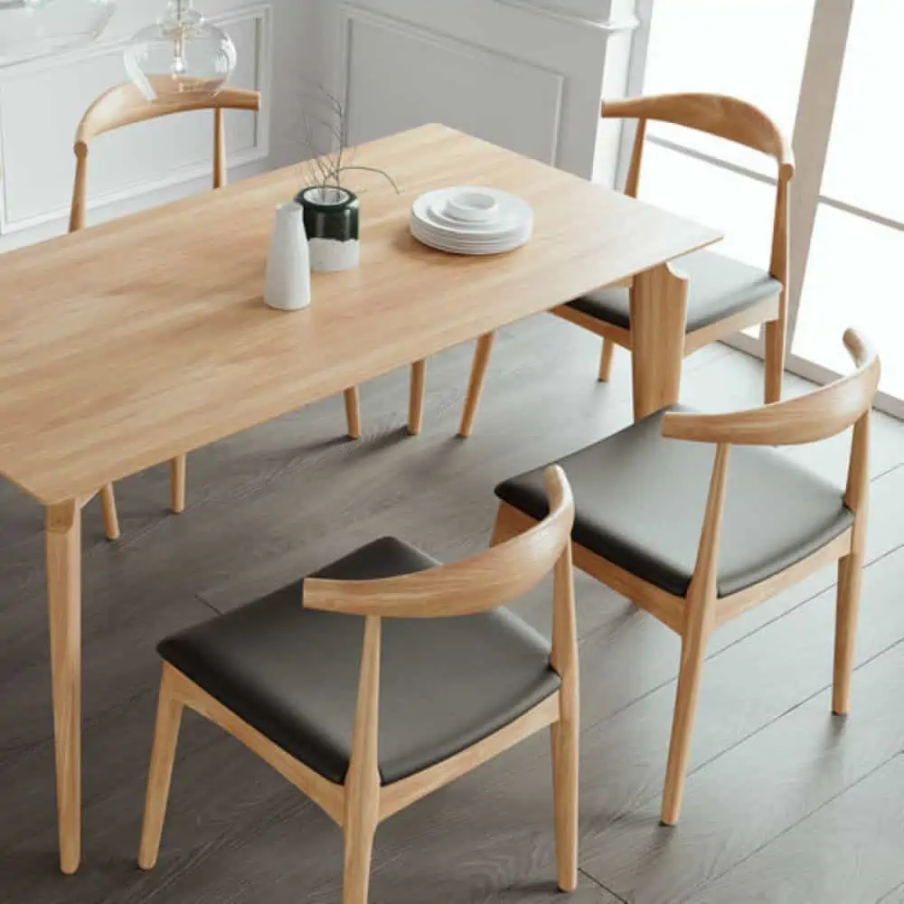 Light wood coloured MDF dining table set, chairs with dark gray seats, in a room with white walls and dark wooden floor