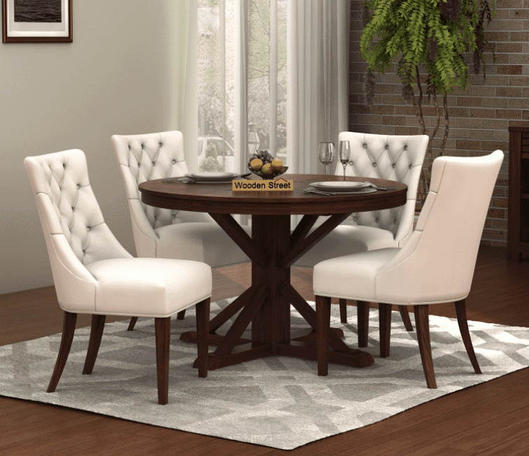 dark brown wooden round dining table with white chairs with wooden legs in a dining room setting