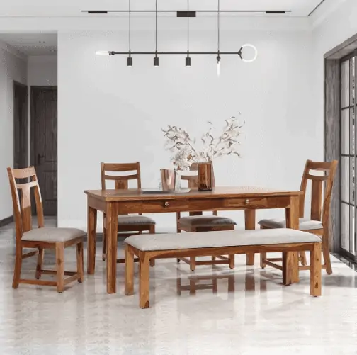 rectangle brown wooden dinner table with 4 chairs and bench, light gray seats in a room