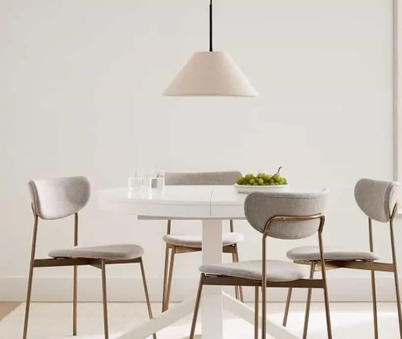 a modern room set in a white room with a bowl of fruits and a lamp in frame.