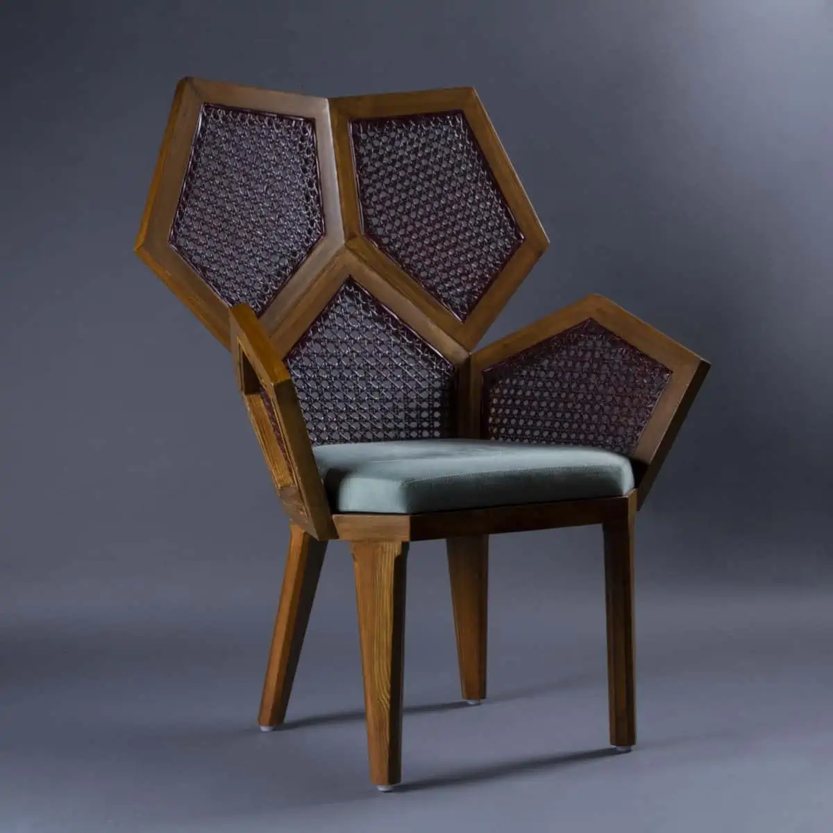 Wooden chair with blue cushioning and eccentric pentagon design