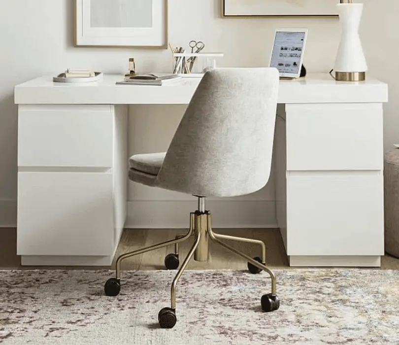 white office and study chair in a home setting with wooden flooring, a multi colored rug, white desk and white lamp