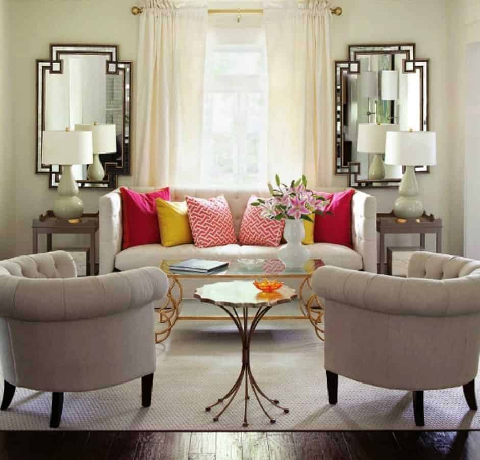 living room with off white symmetrical features in mirror, lamp and sofa