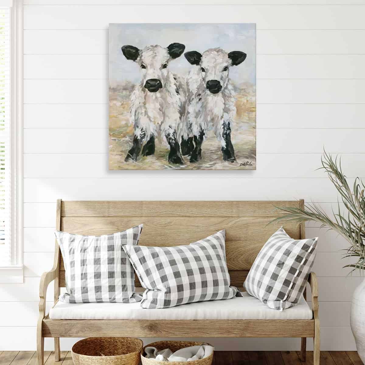 calfs painted on canvas hanging in living room 