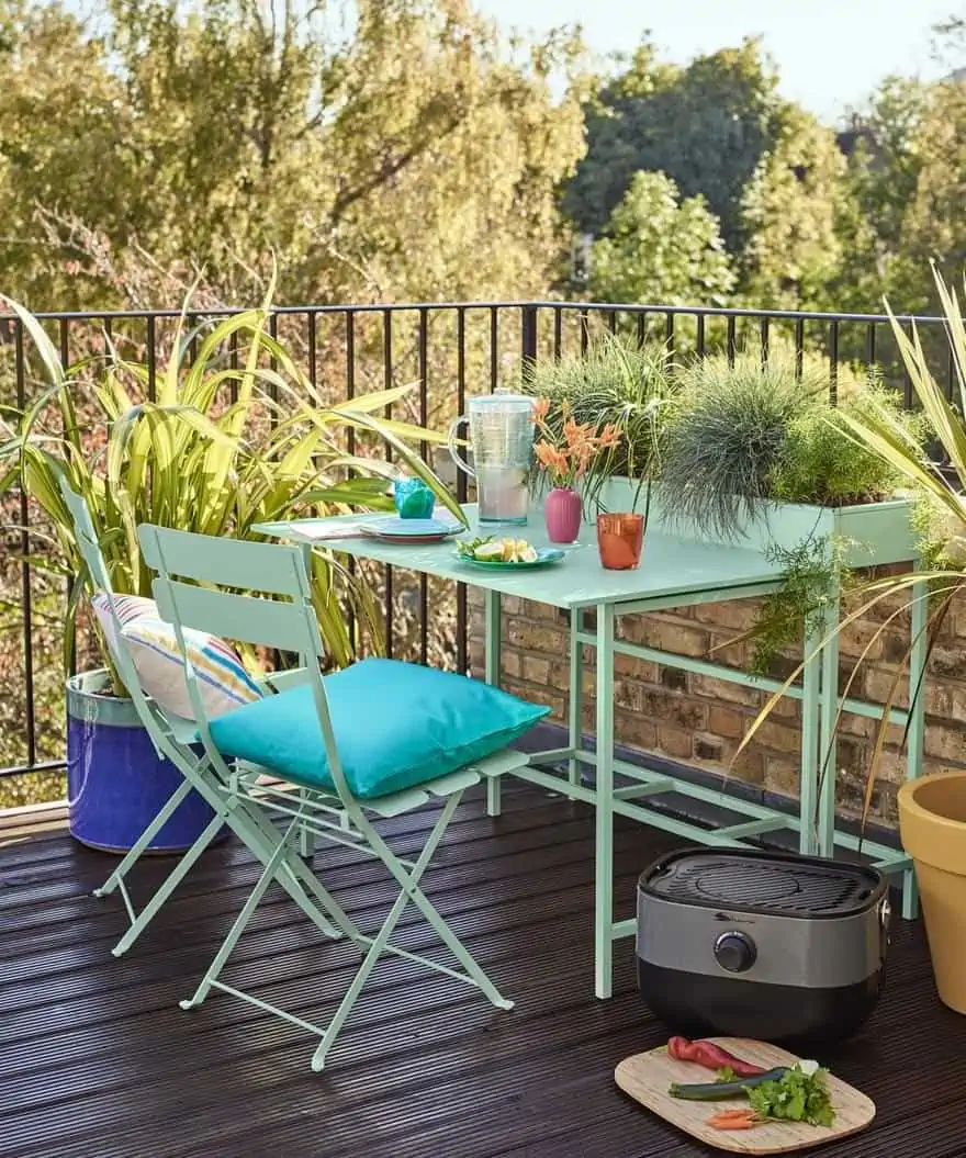 simple blue dining set for two in balcony design with grills around