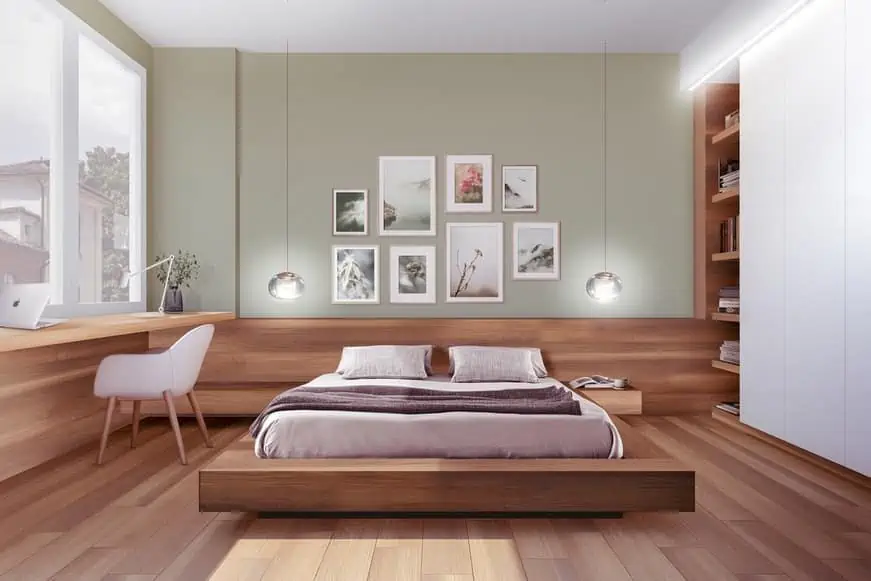a serene bedroom with brown wooden floors and wall gallery