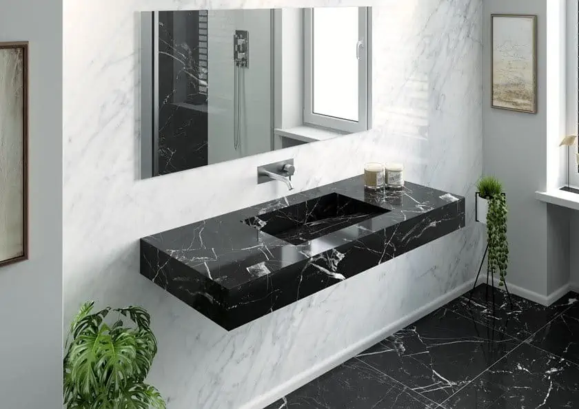 black sink with a mirror, tap and indoor plants