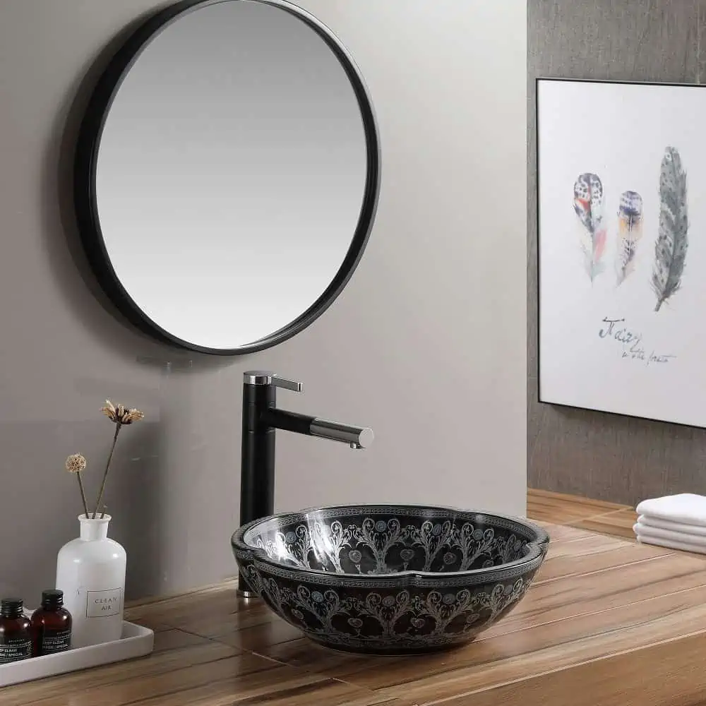 black and white sink with mirrors and a tap