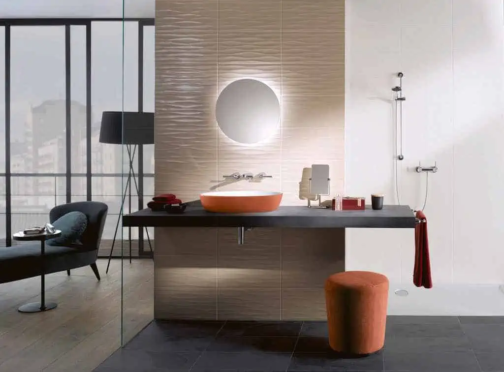 washbasin with a mirror with strip lights and a red stool