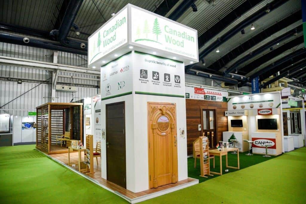 modern furniture and fenestration display at the Canadian Wood booth at IndiaWood 2022, light and dark brown coloured furniture and door designs