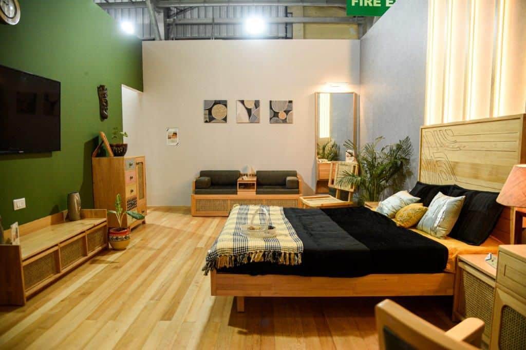 modern bedroom concept by Canadian Wood, wood products - bed, flooring, sofa, table, chairs, and sideboard showcased by Canadian Wood at IndiaWood 2022