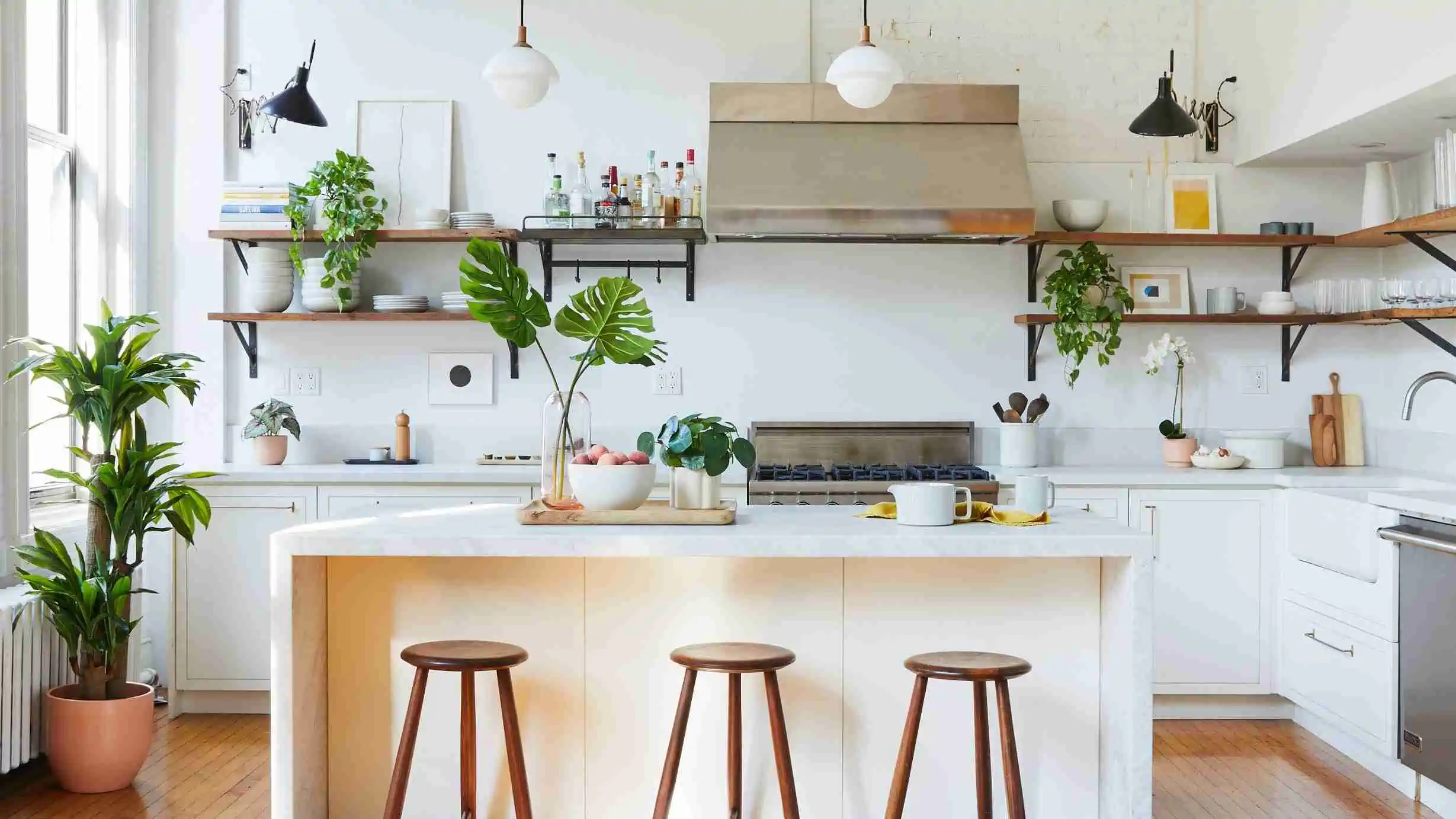 green plants in a kitchen with a table and three chairs