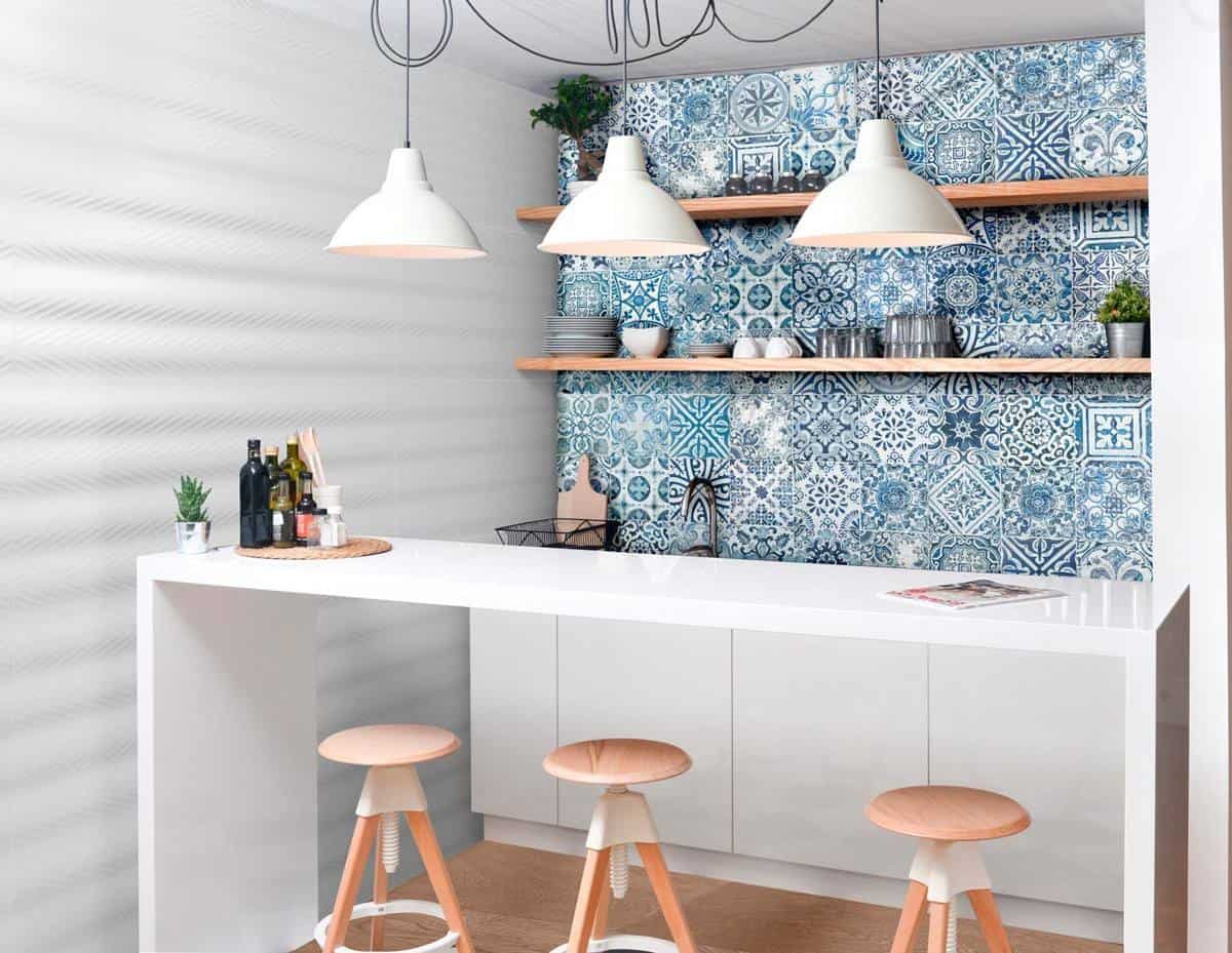 white kitchen interiors with blue wall paper with three chairs and ceiling lights