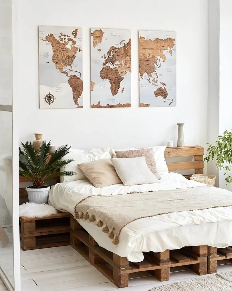 world map wall decoration in bedroom with indoor plants and white walls