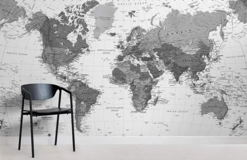 Black and white world map wall decoration with a black chair