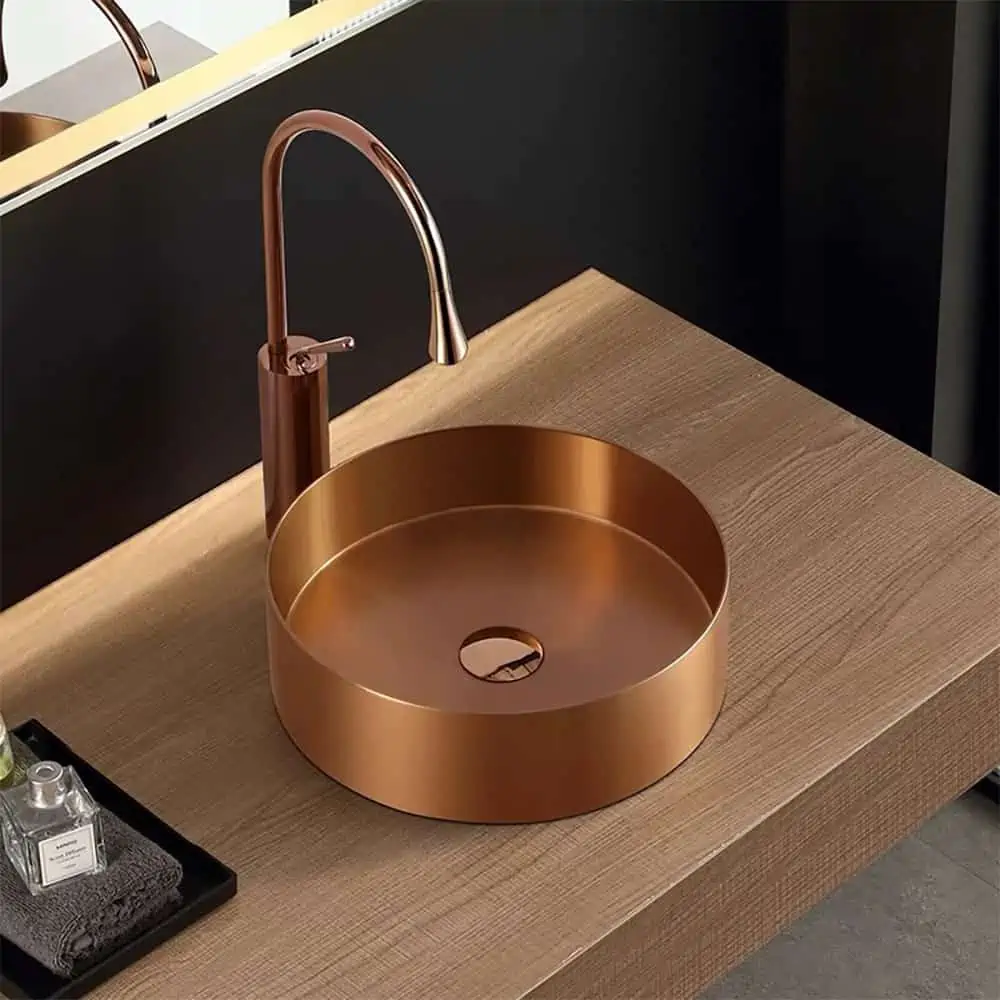 Bronze washbasin with a tap in a bathroom
