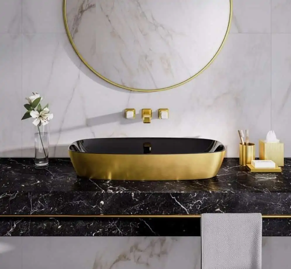 black bathroom with golden washbasin, a tap and a mirror