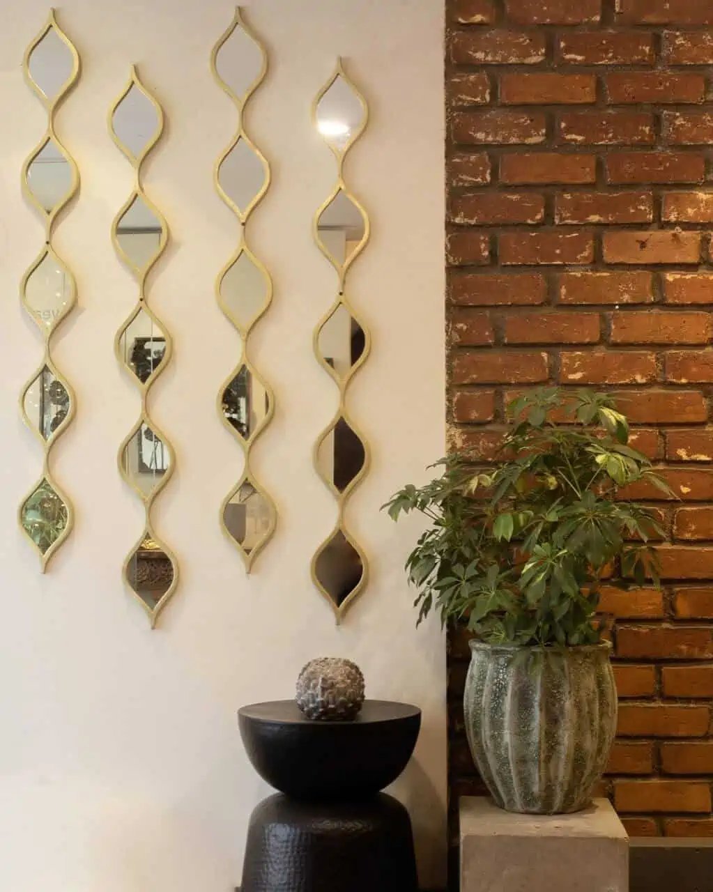 mirror wall decor with brown brickwork and potted plants