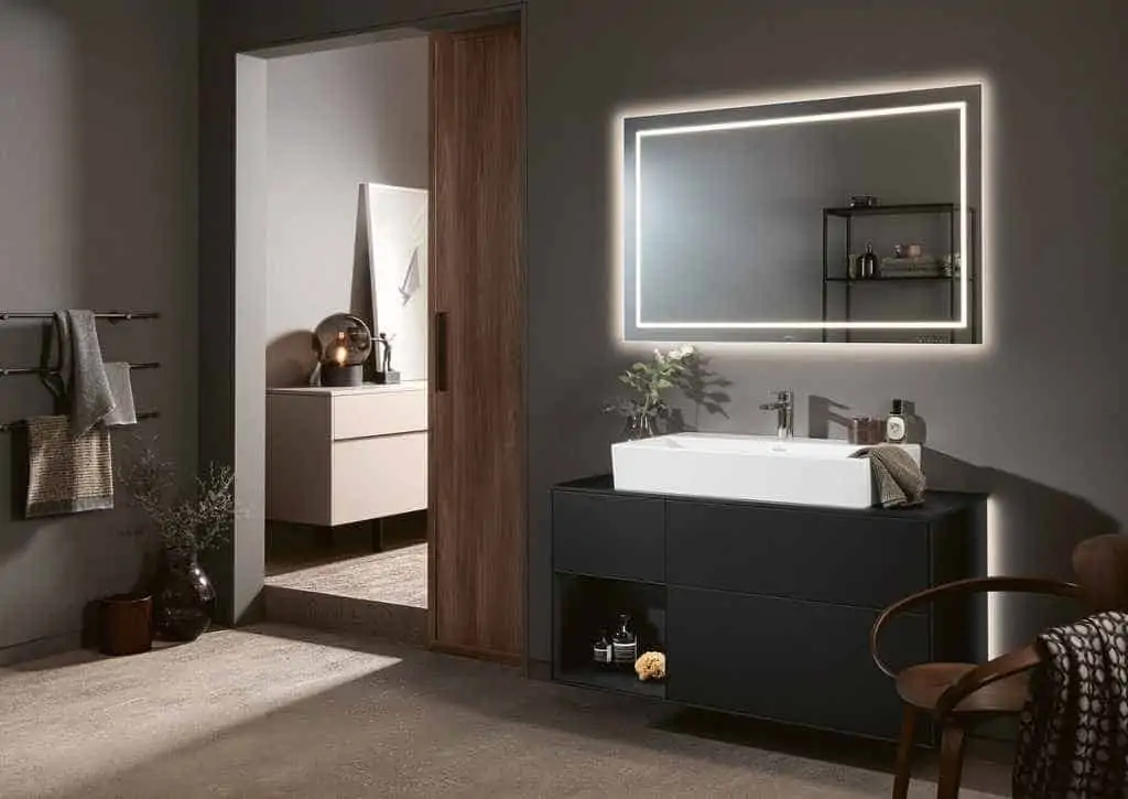 stunning mirror in a bathroom with white sink and black cabinet