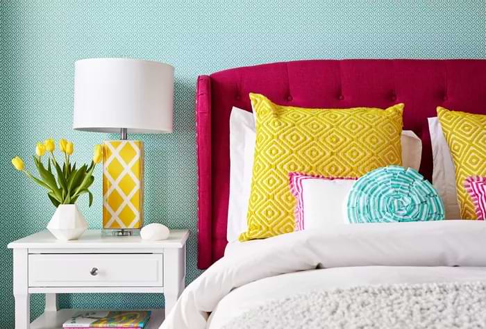 Triadic colour scheme bedroom with pink headboard