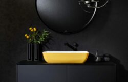 villeroy & boch ARTIS - yellow countertop washbasin mounted on matte black vanity in a modern black bathroom