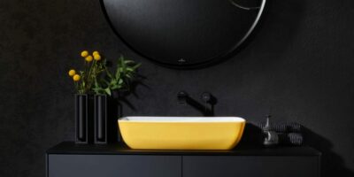 villeroy & boch ARTIS - yellow countertop washbasin mounted on matte black vanity in a modern black bathroom