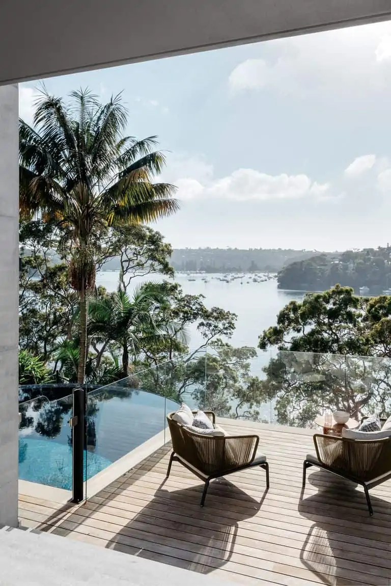 luxury balcony with glass railings and blue lake view