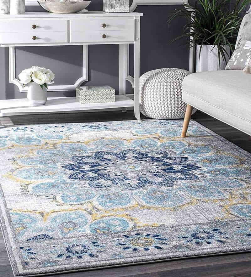 blue patterned rug with white furniture and grey walls