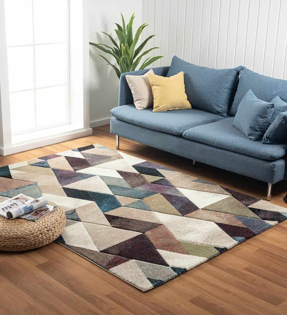 geometric pattern type carpet with blue sofa in a living room