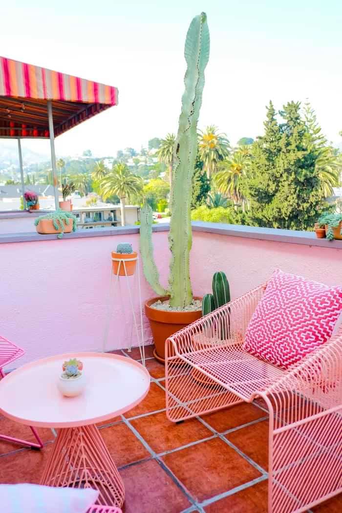 Pink balcony design with statement chair decor with grill type pattern