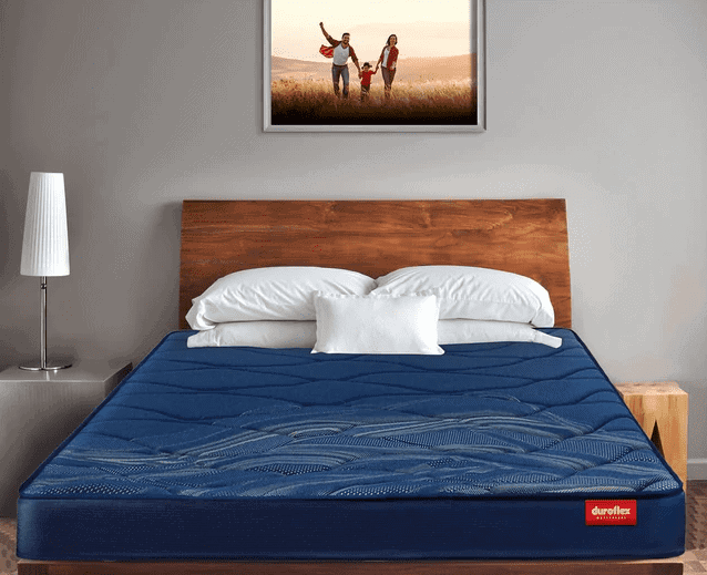 wall hanging, bedroom, dark blue mattress from good mattress brand, white pillows, bed
