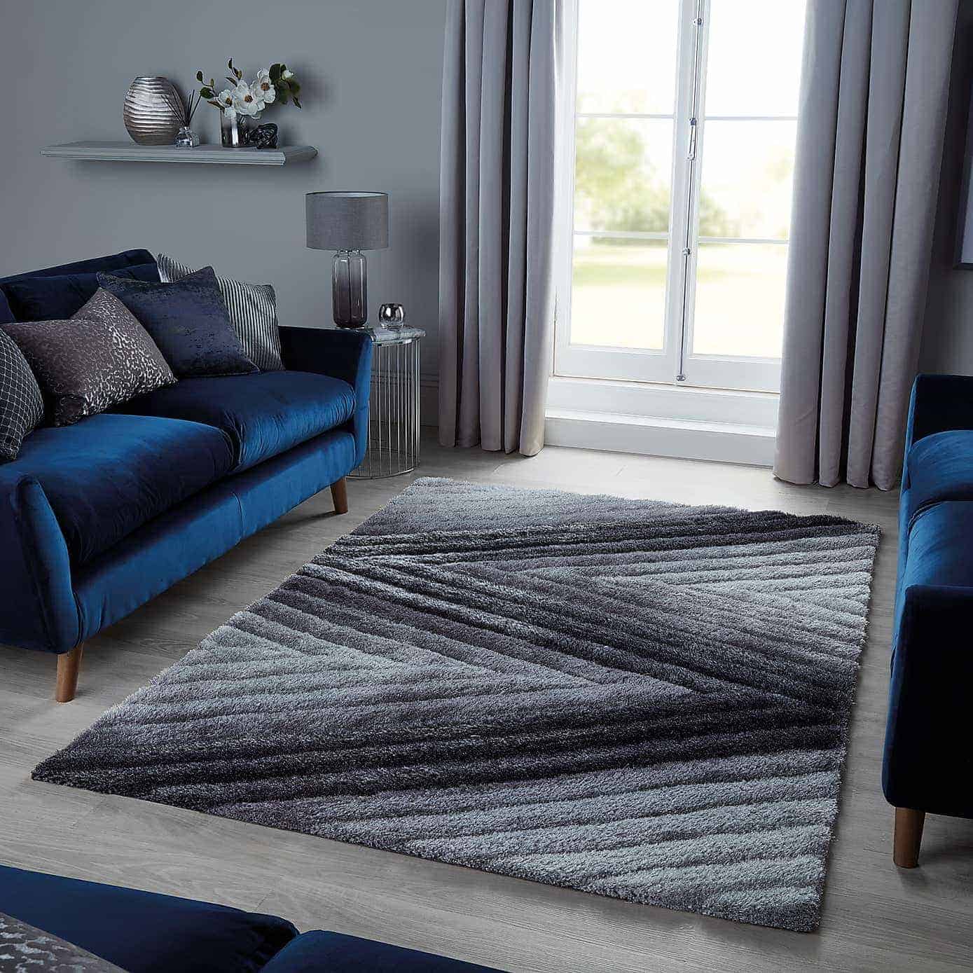 black and grey rug with blue sofas