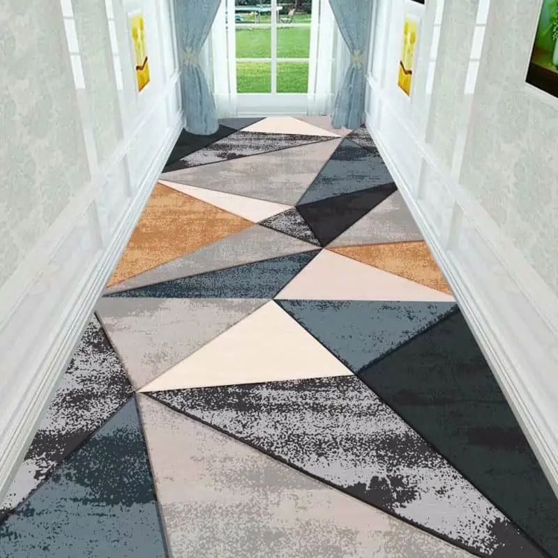 hallway with multicolor ground covering with blue curtains and a door