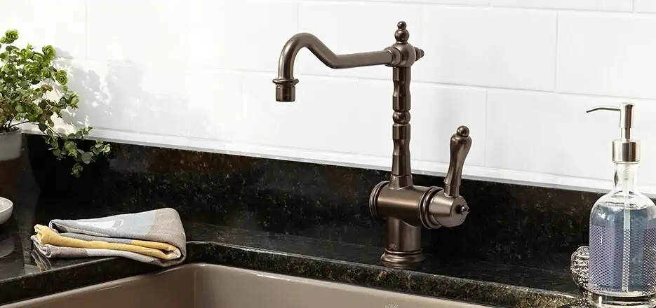 kitchen faucet with white walls and a sink