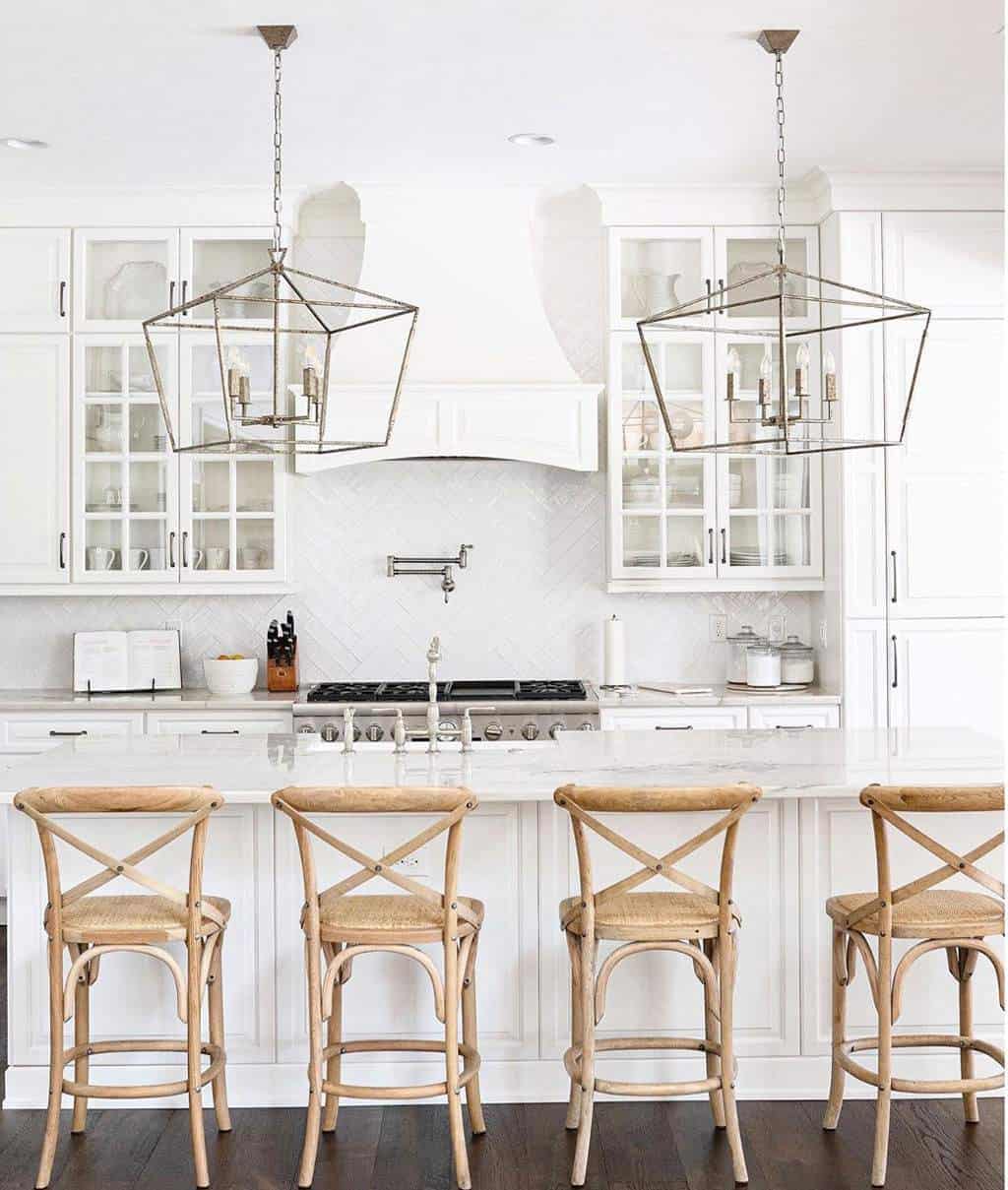 white kitchen interiors with brown chairs and ceiling lights