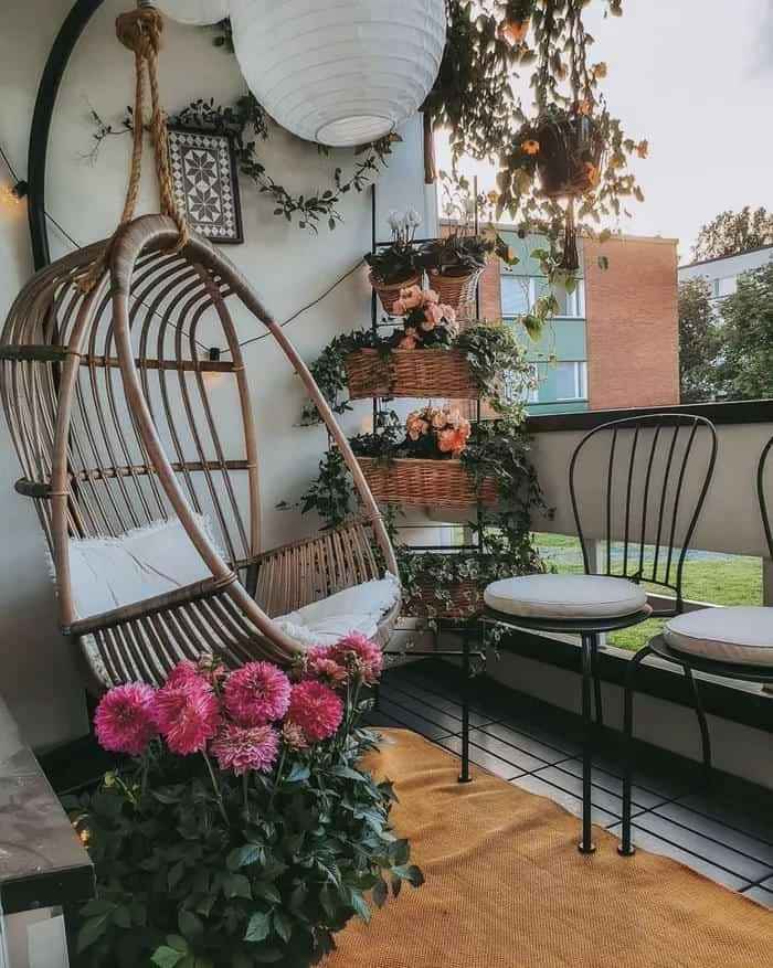 Small patio with hanging chair and roses in pink