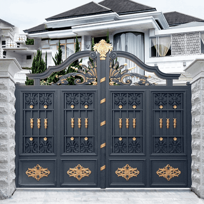 black iron main gate with golden decorations in front of bungalow