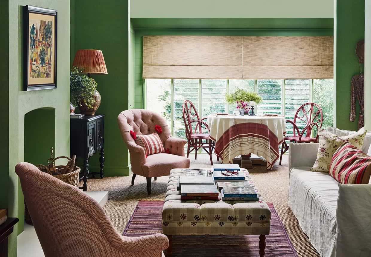 Small living room interior design decoration idea with green colour wall and pink seating furniture 