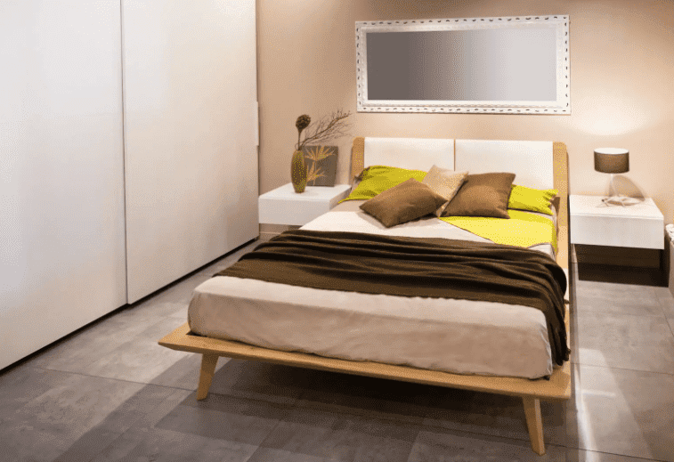 bedroom, bed, pillows, music system, light yellow walls, mattress from top quality mattress brands in India with best price