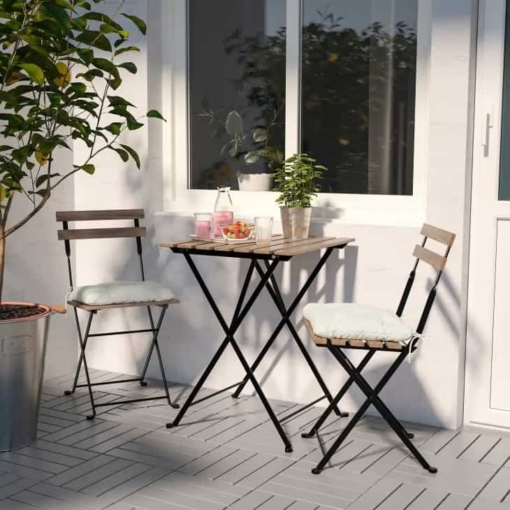 White colour classic balcony with foldable chairs and table