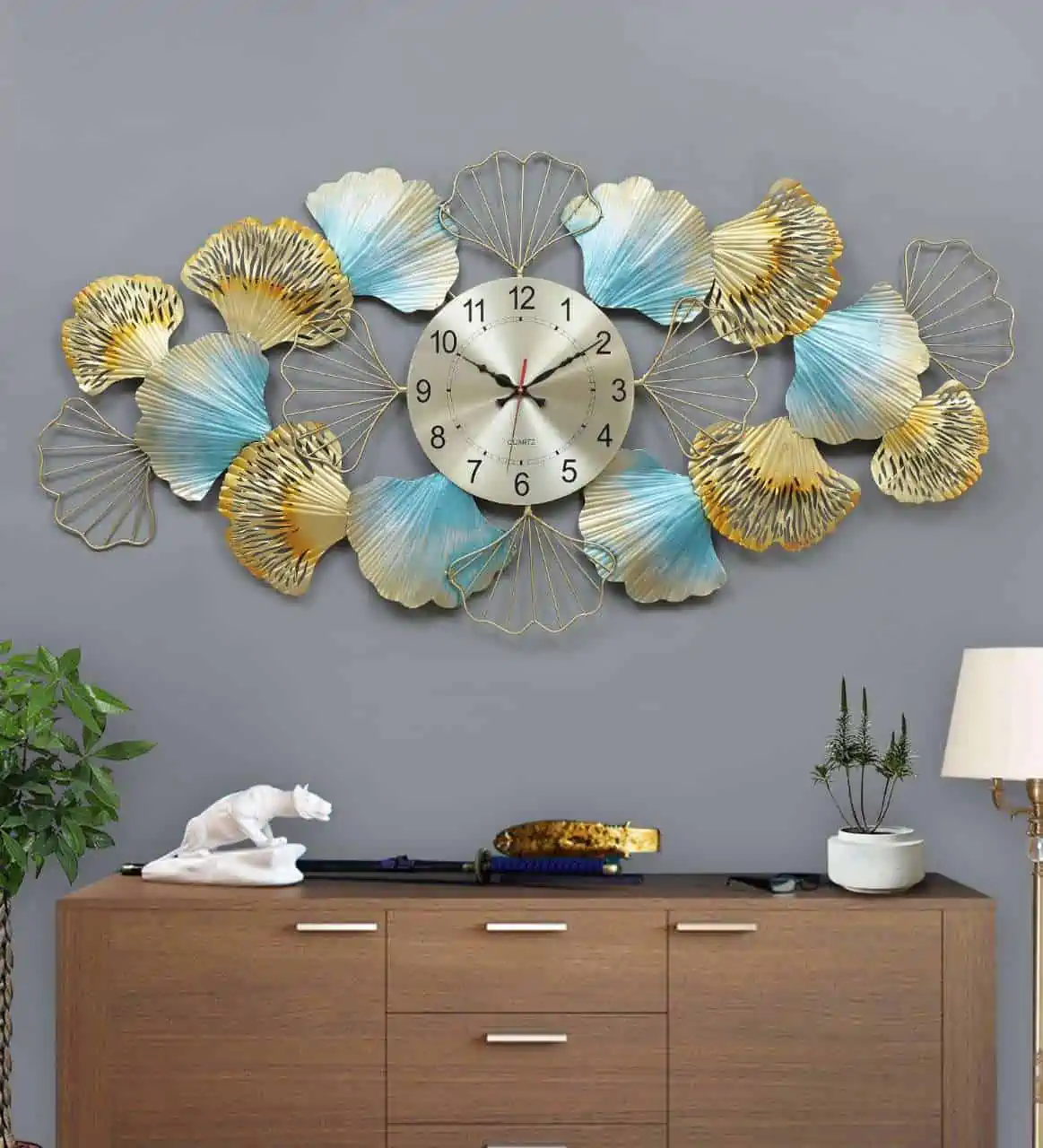 statement wall clock on a grey wall and wooden table ideas for wall decoration in living room