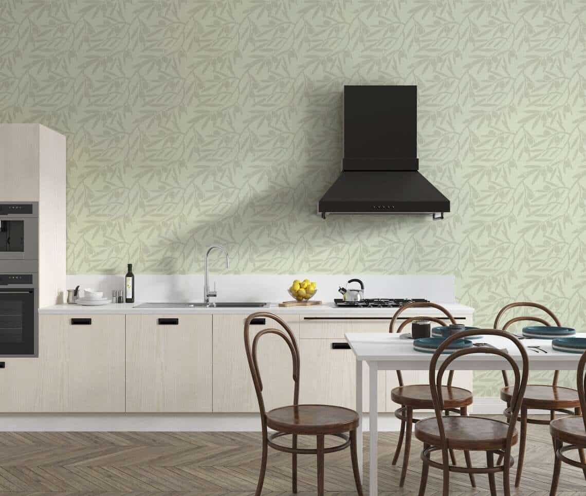 green wallpaper in a kitchen with wooden dining table and black chimney