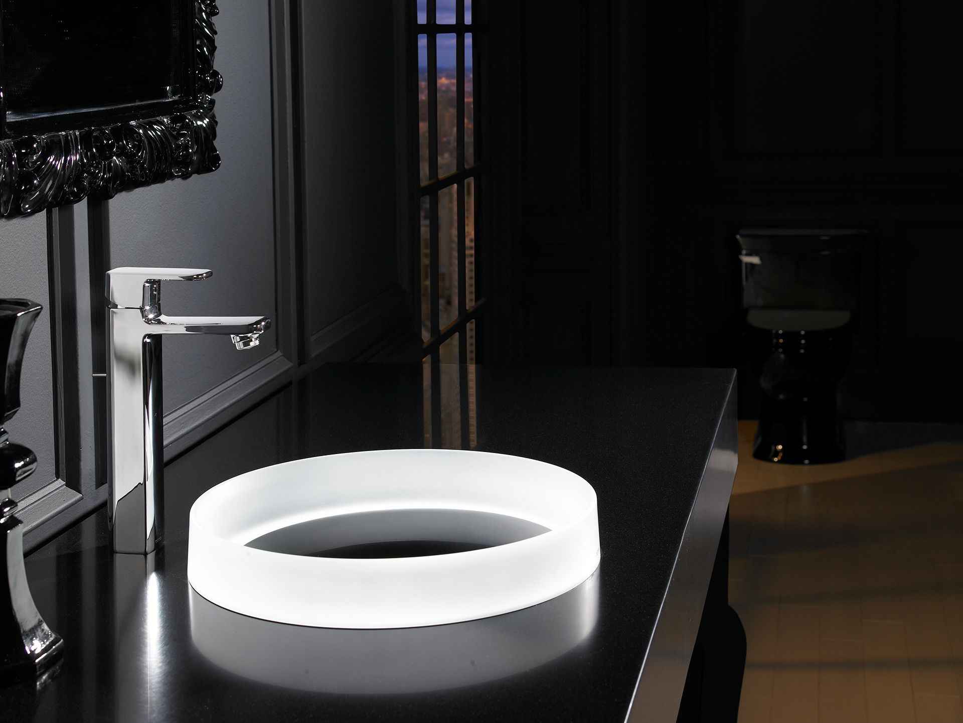 luminous sink with a silver tap in a bathroom