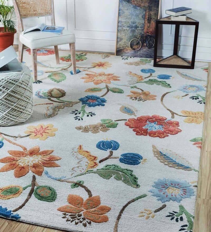 white floral rug with a chair and table