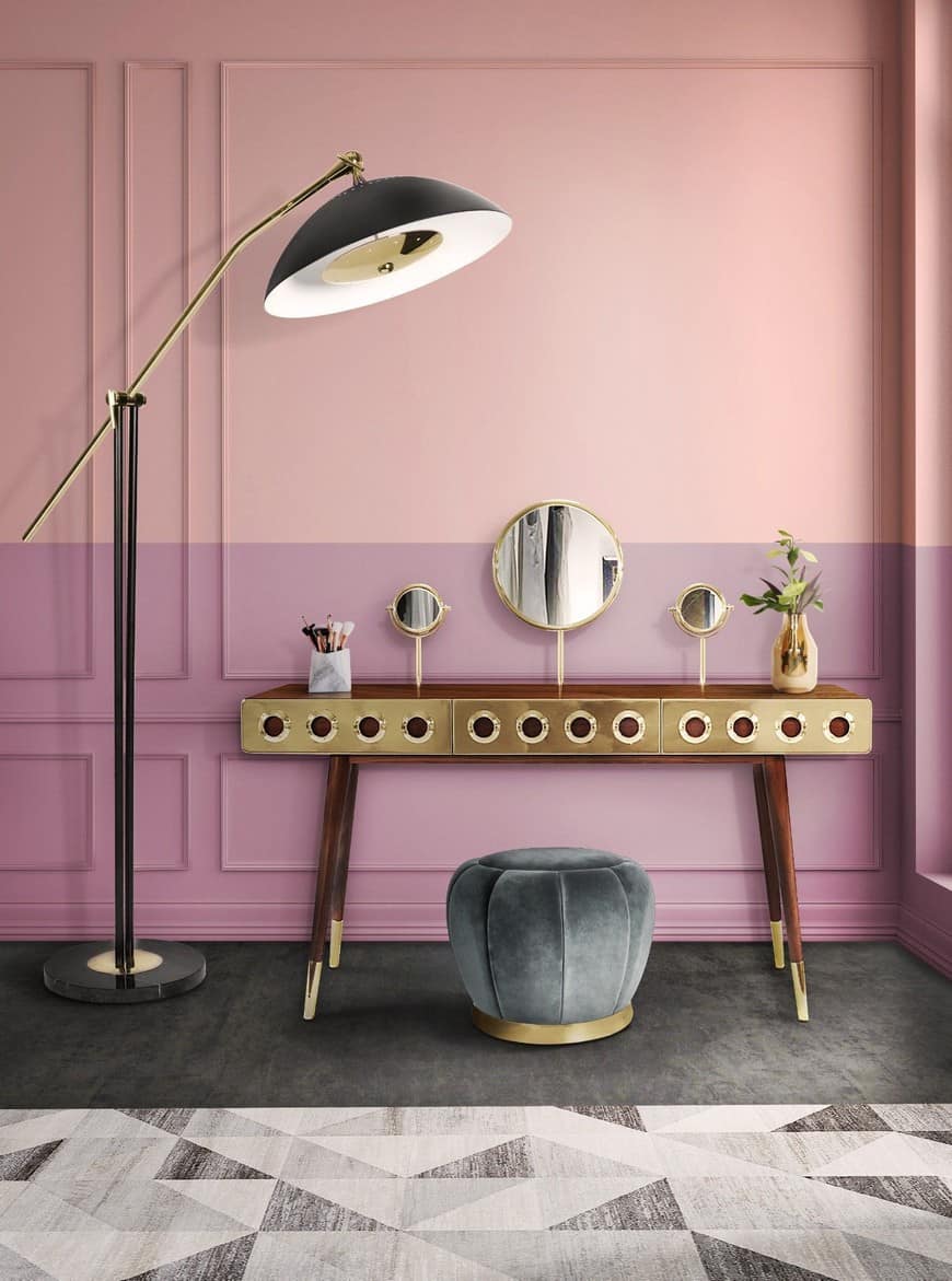 A graceful dressing table design with round mirrors, minimum storage space, and a matching stool, in a pink room.